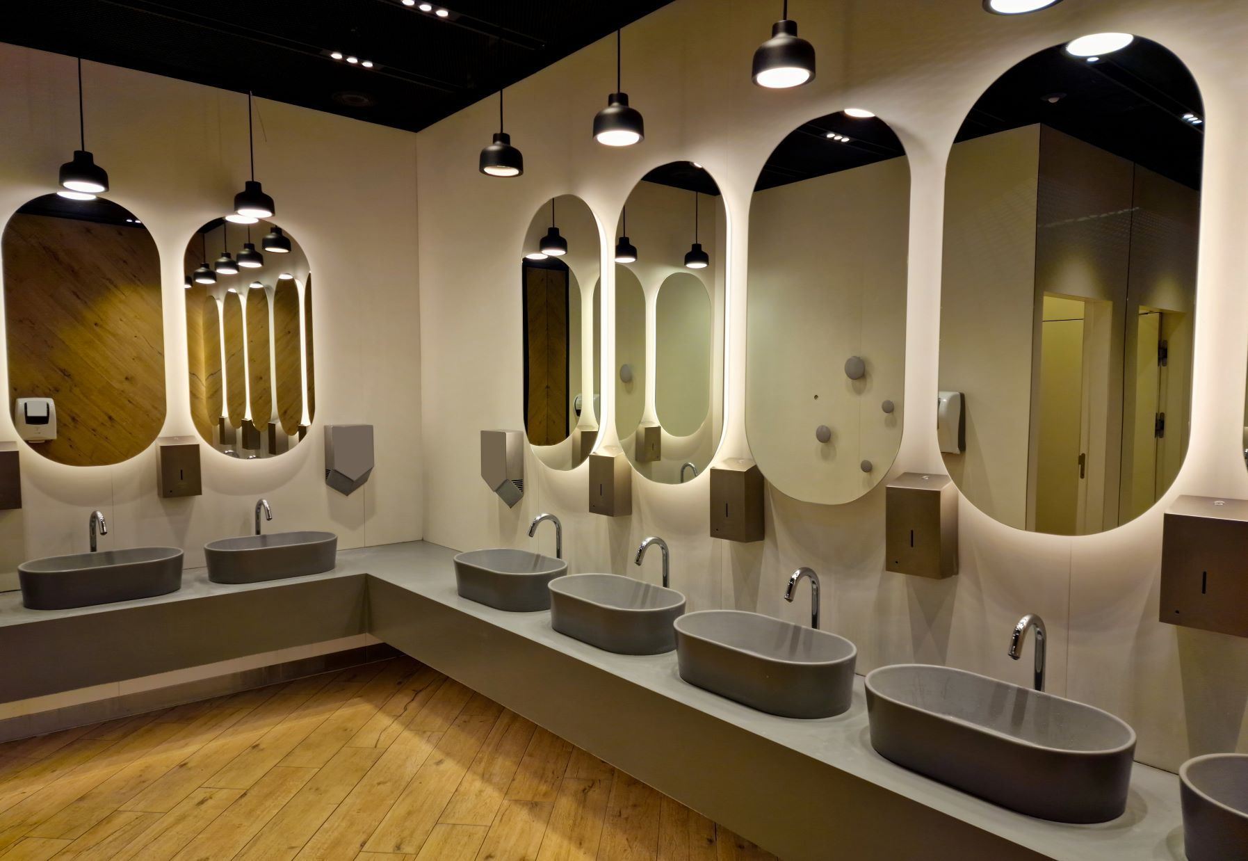 A bathroom with a lot of sinks and mirrors
