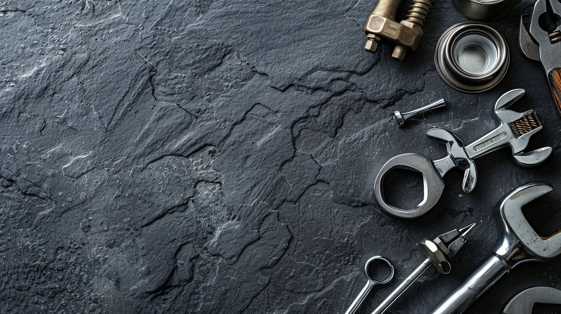 Un tas d'outils sont posés sur une surface noire.