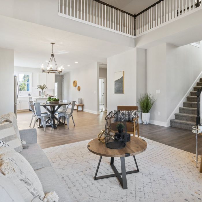 A living room with a couch a table and chairs