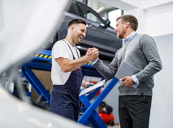 Mechanic and Man Shaking Hands — Austin, TX — Alliance Collision Centers