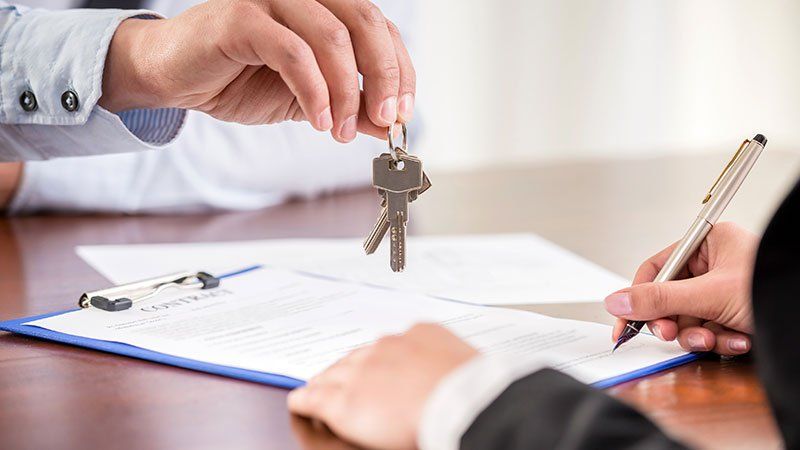 handing over keys to a person buying a home