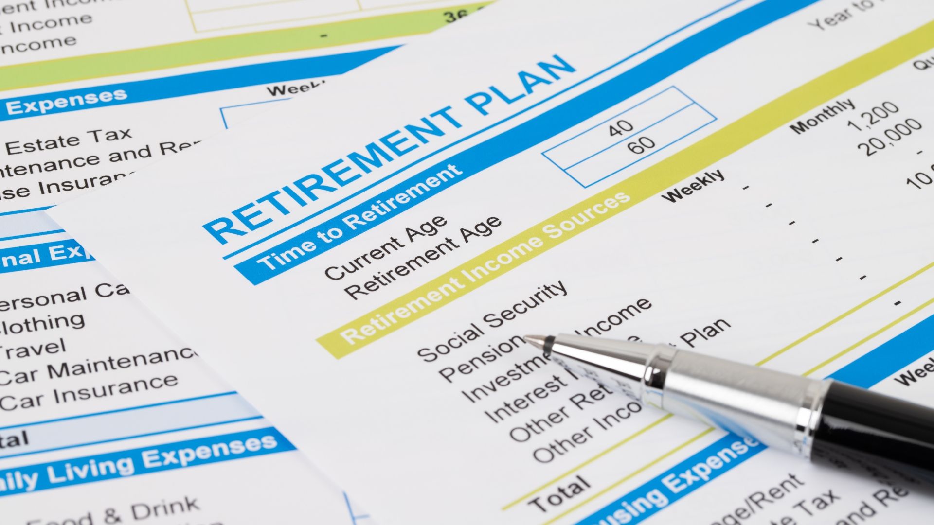 A pen rests on a retirement planning form featuring sections for income sources and expenses.