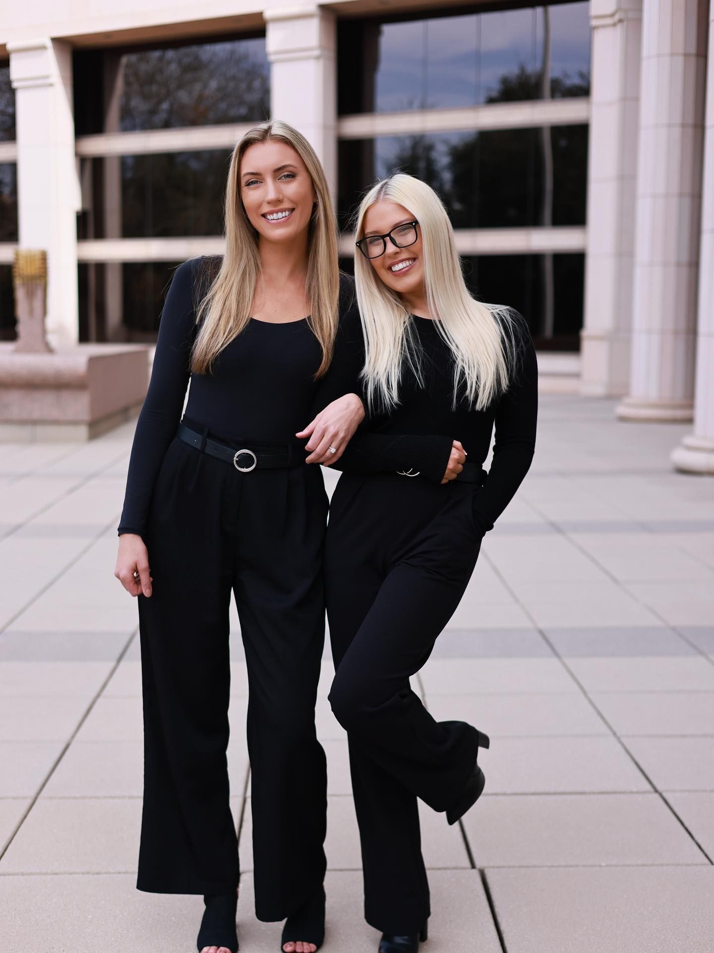 Group of seven people standing in front of a building with glass doors and the number 3011.