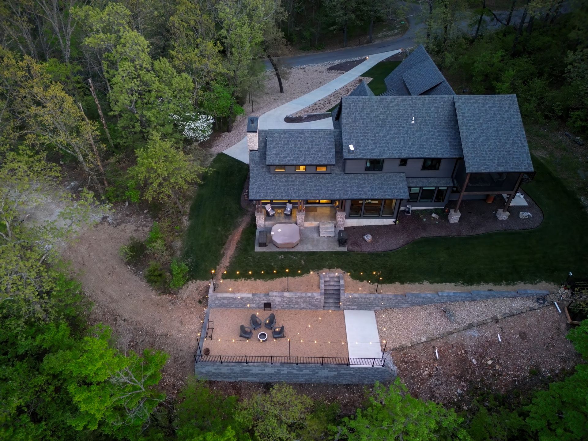 An aerial view of a large house surrounded by trees.