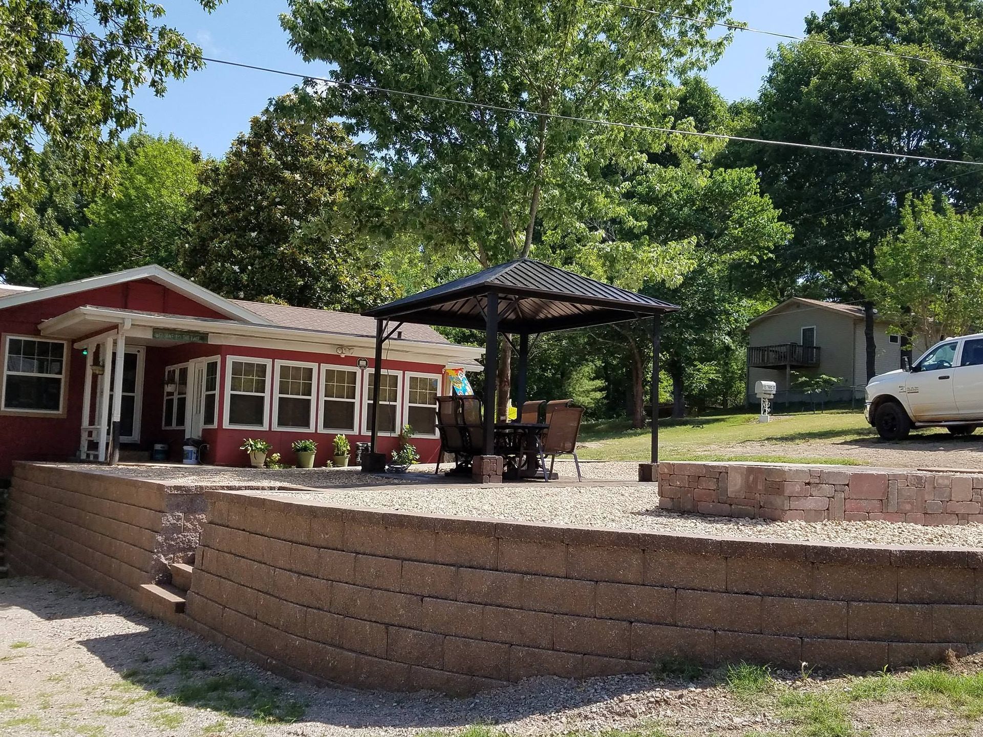 A red house with a white truck parked in front of it