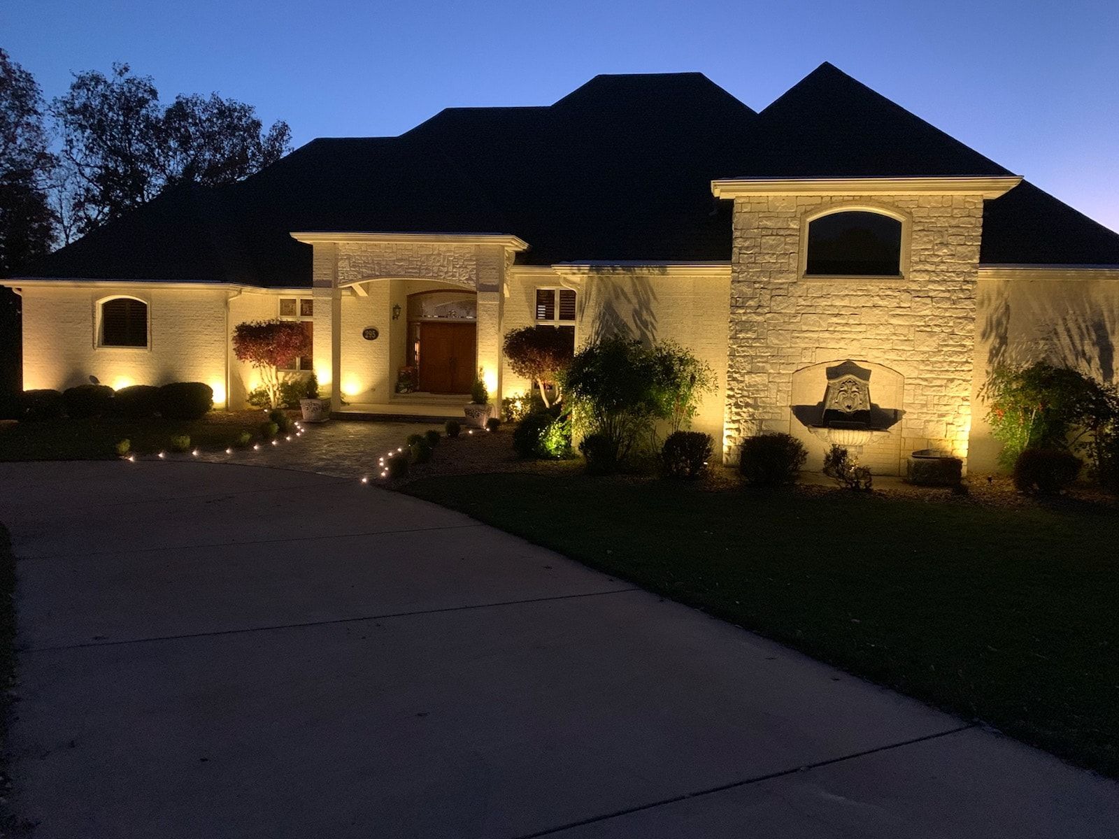 The front of a house is lit up at night