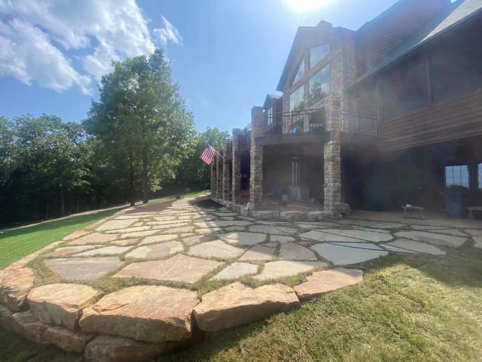 A large house with a large stone walkway in front of it.