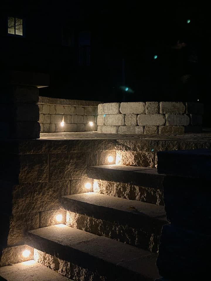 A set of stairs with lights on them at night.