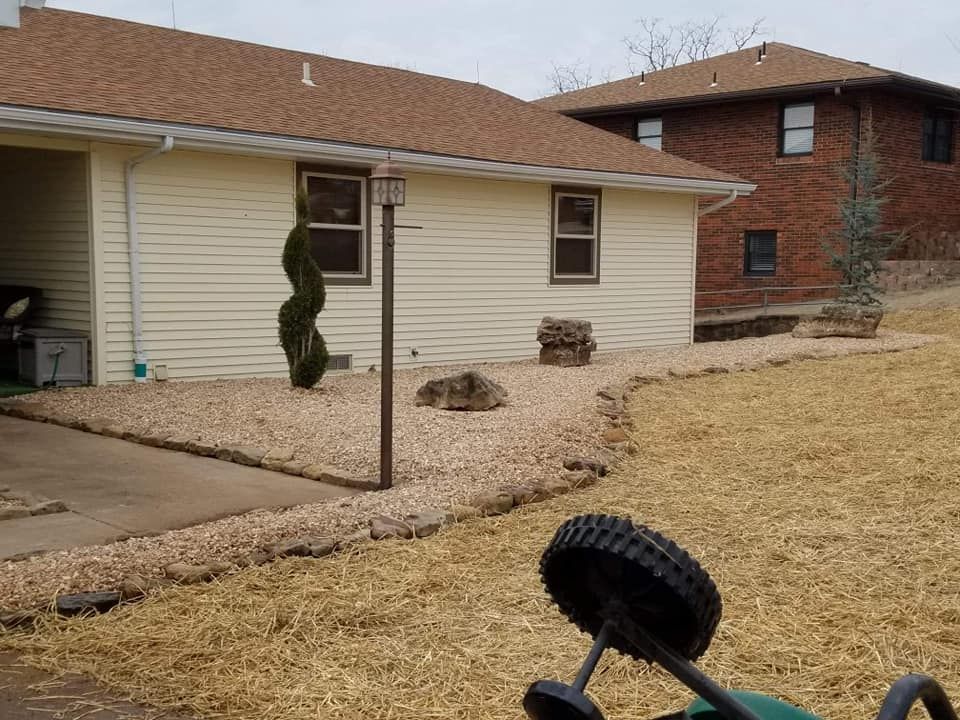 A house with a lawn mower parked in front of it