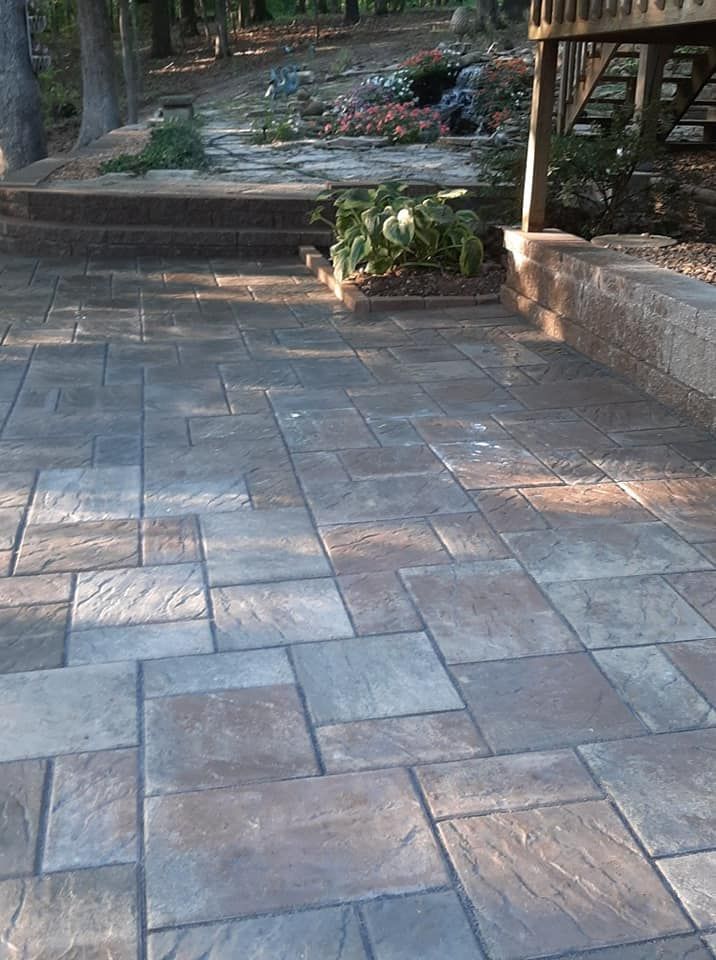 A patio with a staircase and plants on it