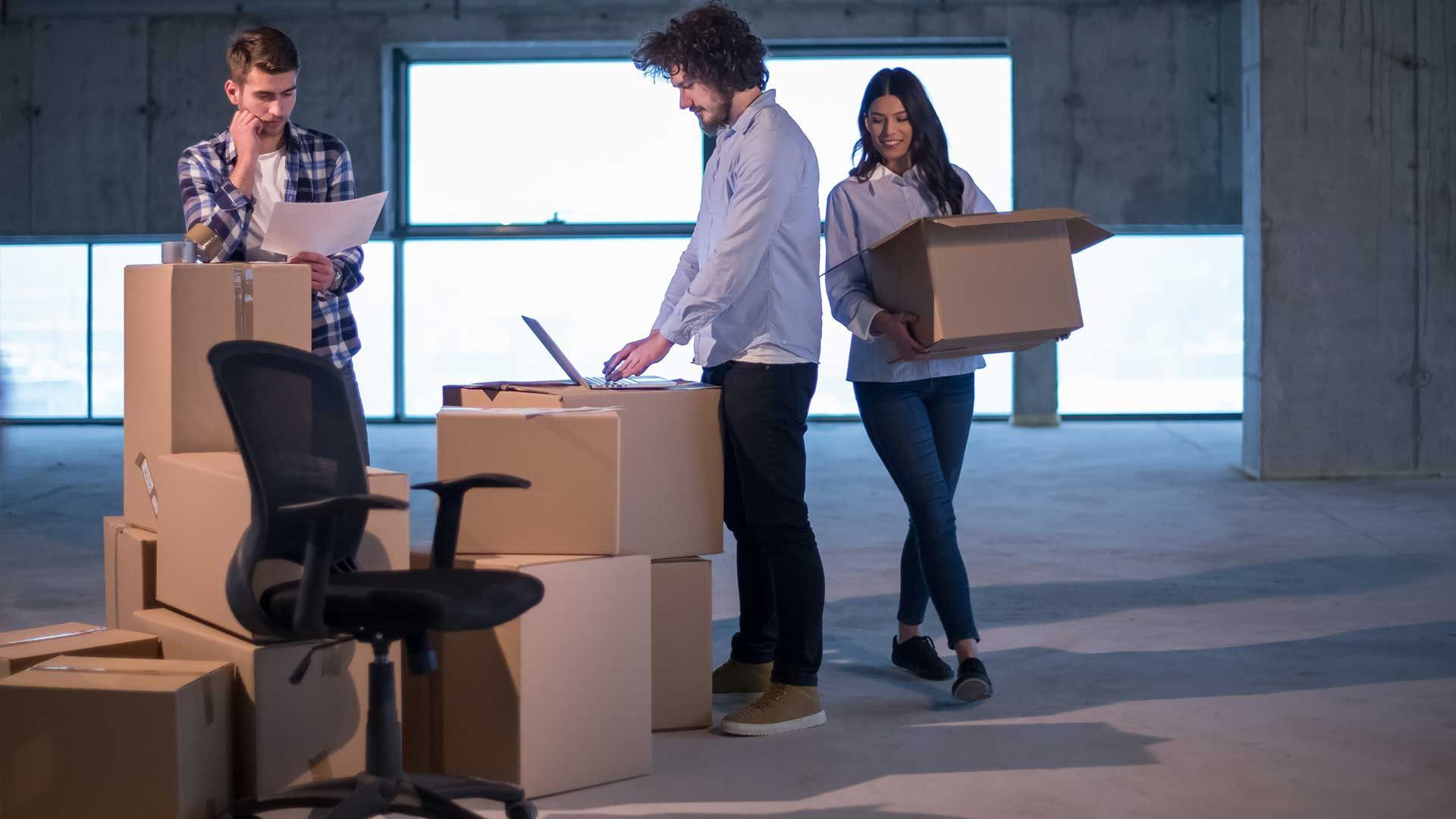 A group of people are moving into a new office.