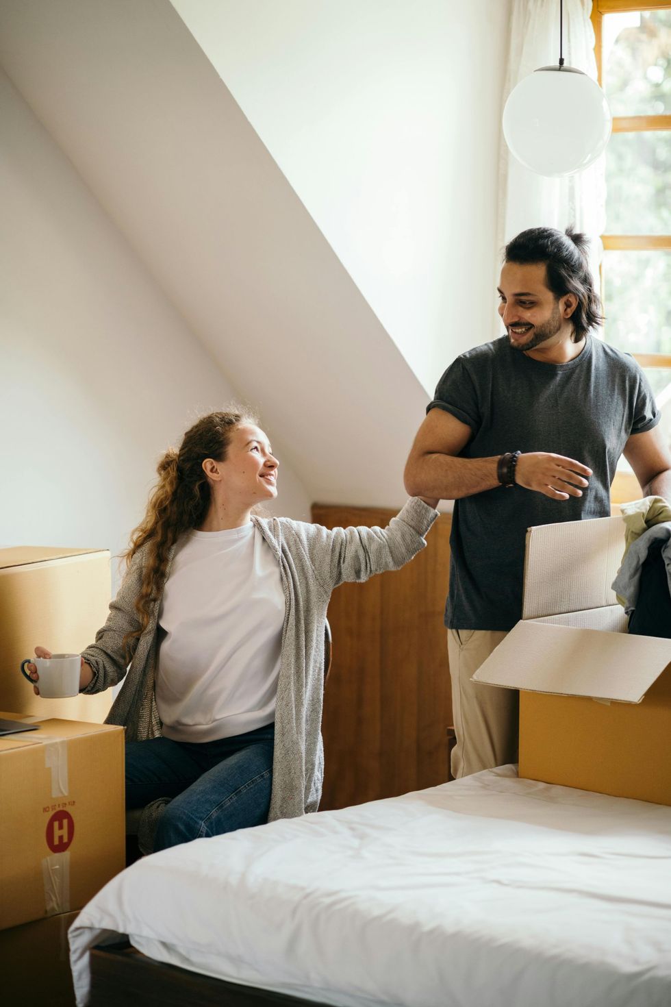 A man and a woman are moving into a new home.