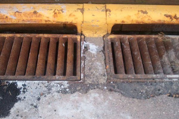 A close up of a rusty drain on the ground