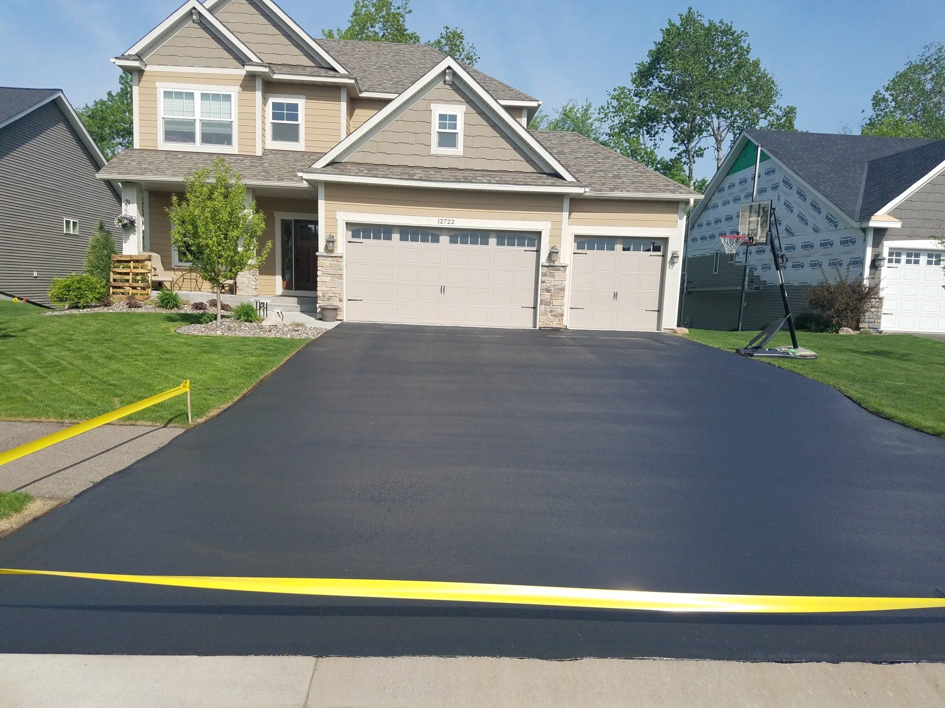 A large house with a large driveway in front of it.