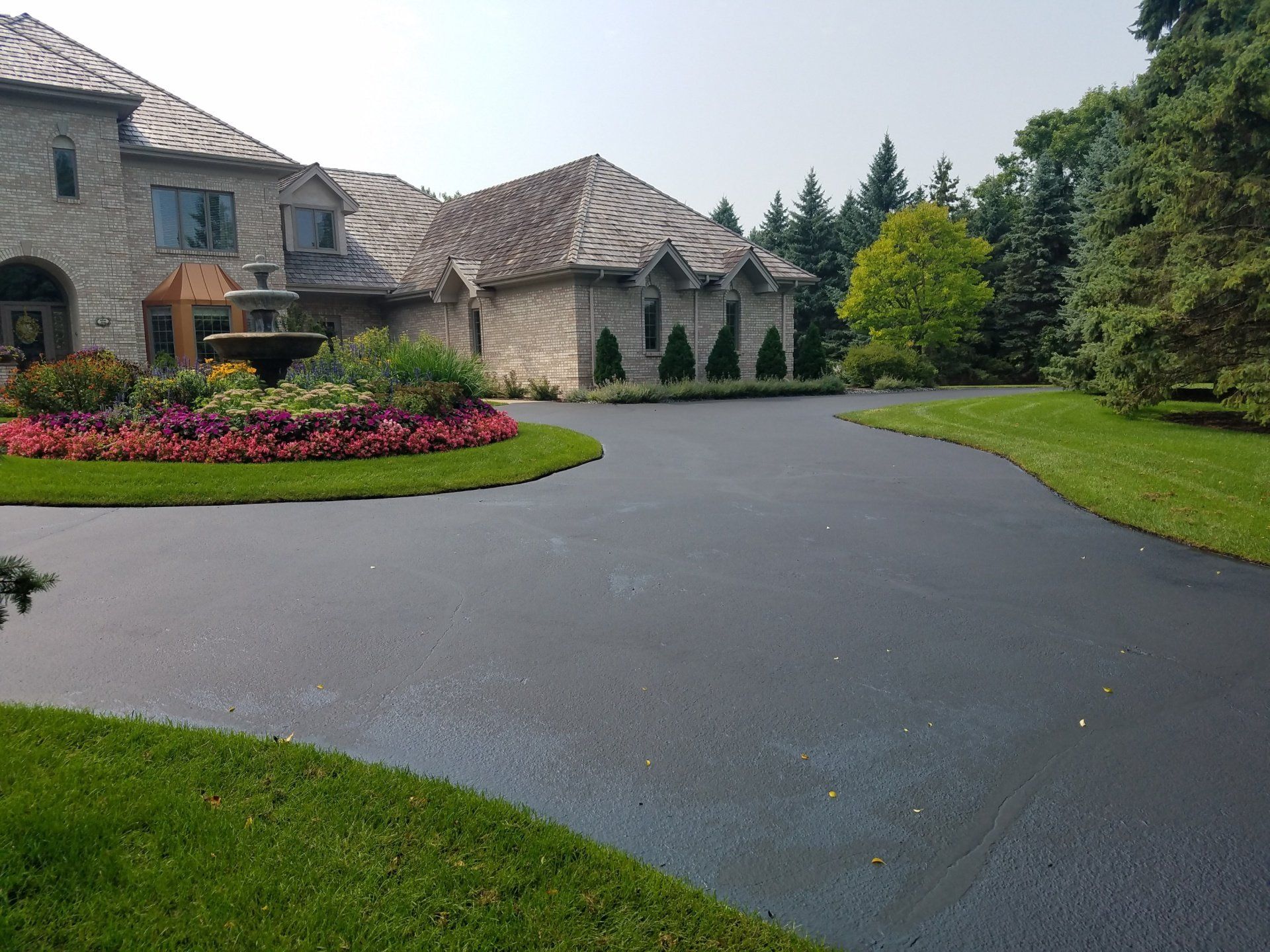 A large house with a large driveway leading to it
