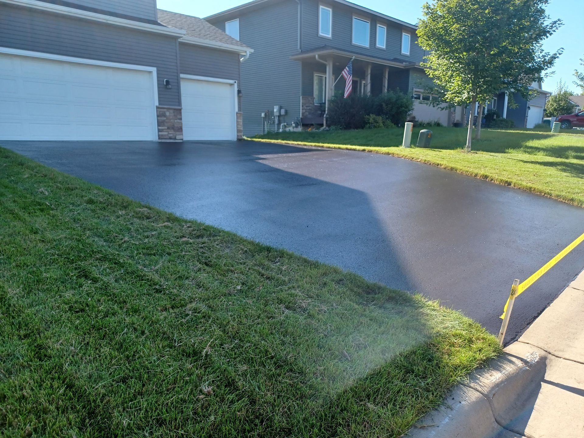 A driveway that has been paved in front of a house.