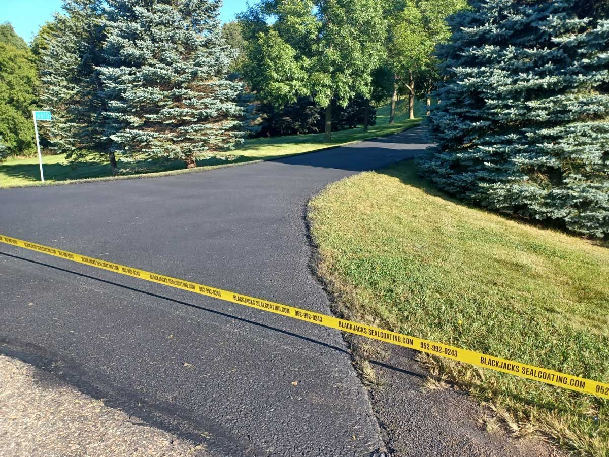 A road with a yellow tape along the side of it.