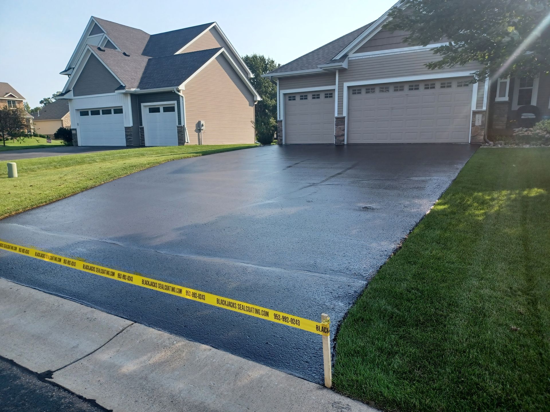 A driveway leading to a house with two garage doors