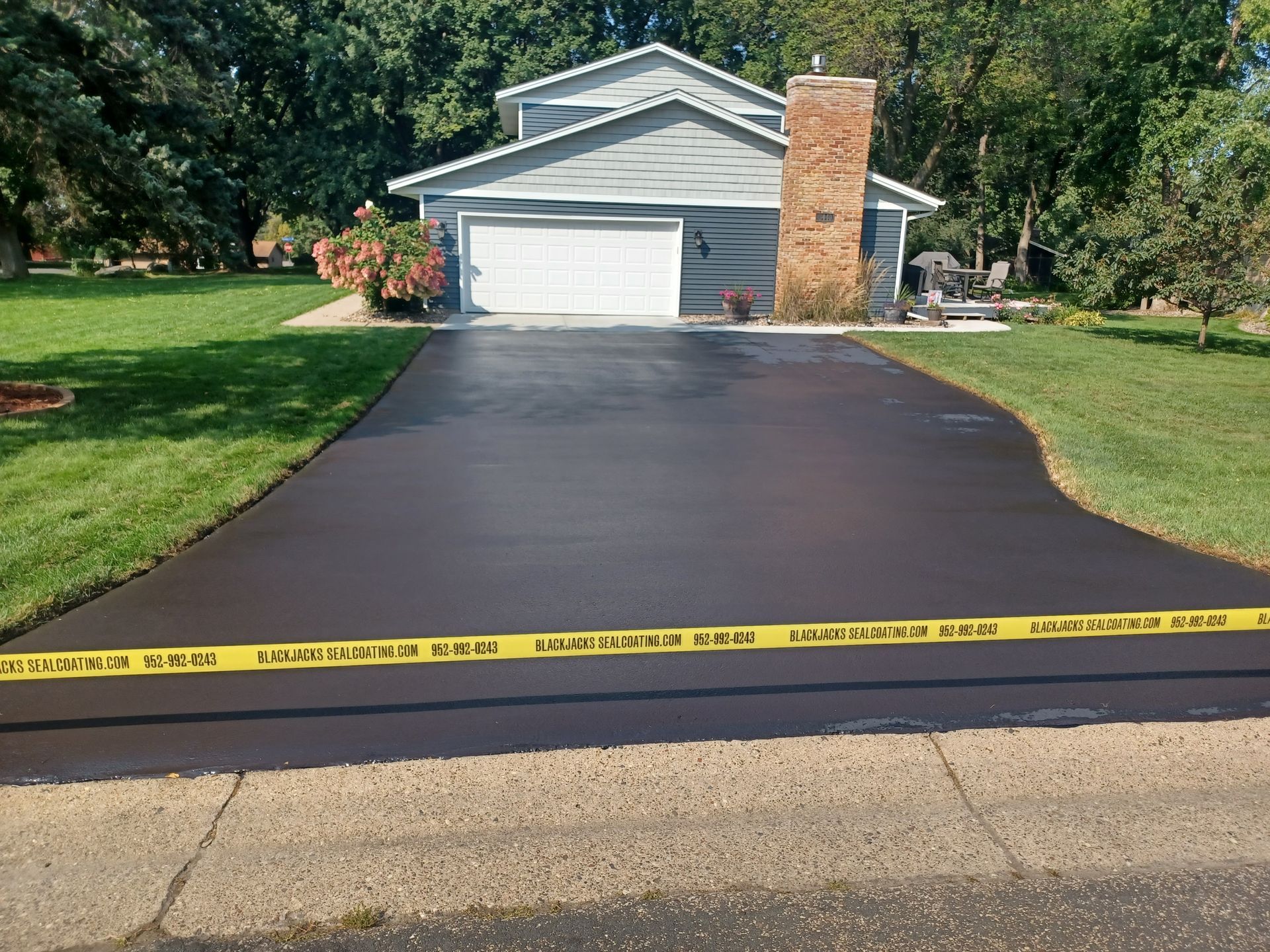 A driveway that has been paved in front of a house.
