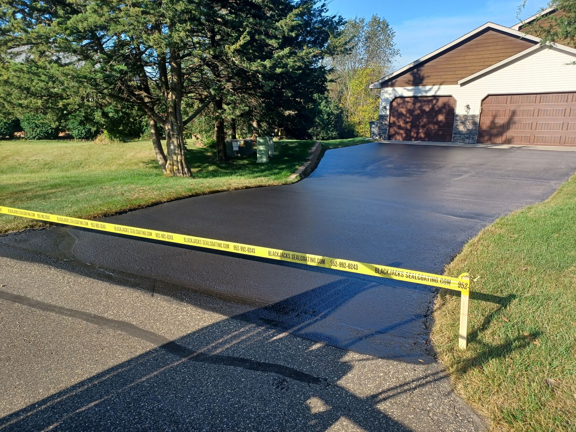 A driveway is being paved in front of a house.