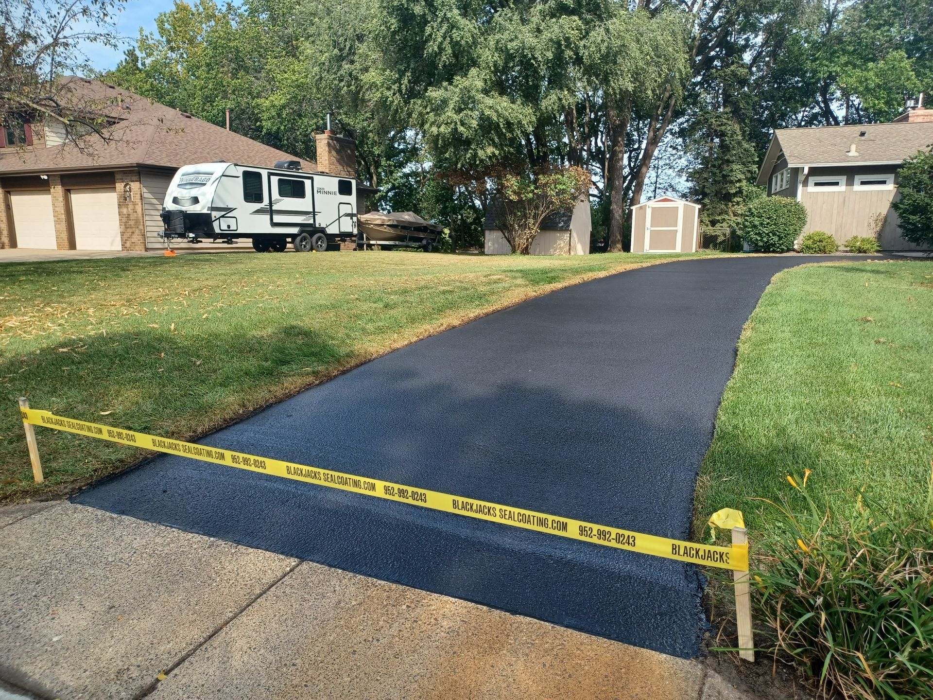 A driveway is being paved in front of a house.