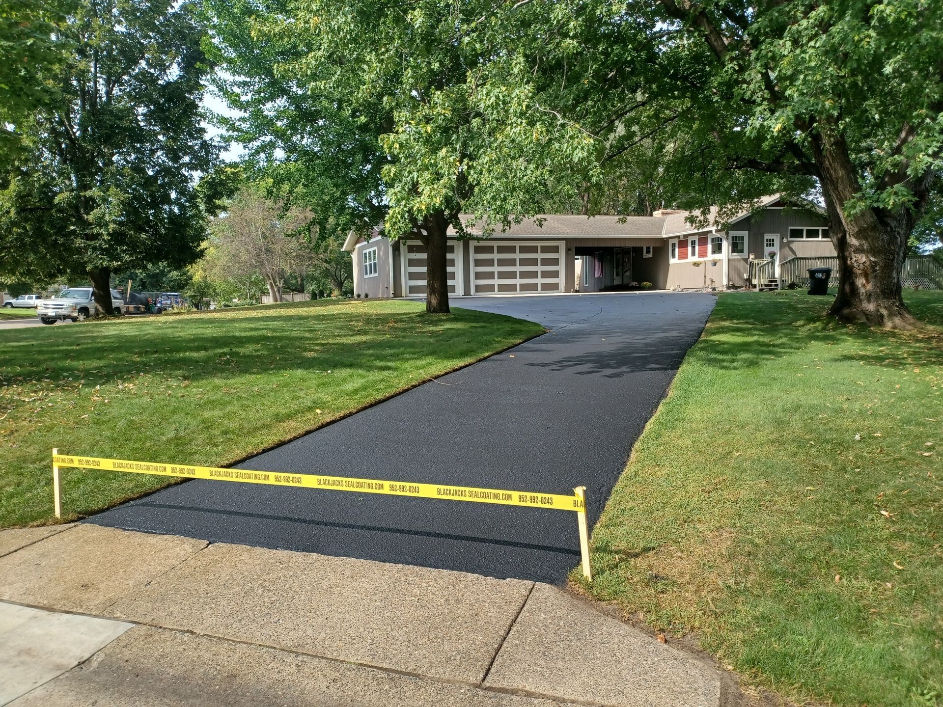 A driveway is being paved in front of a house.