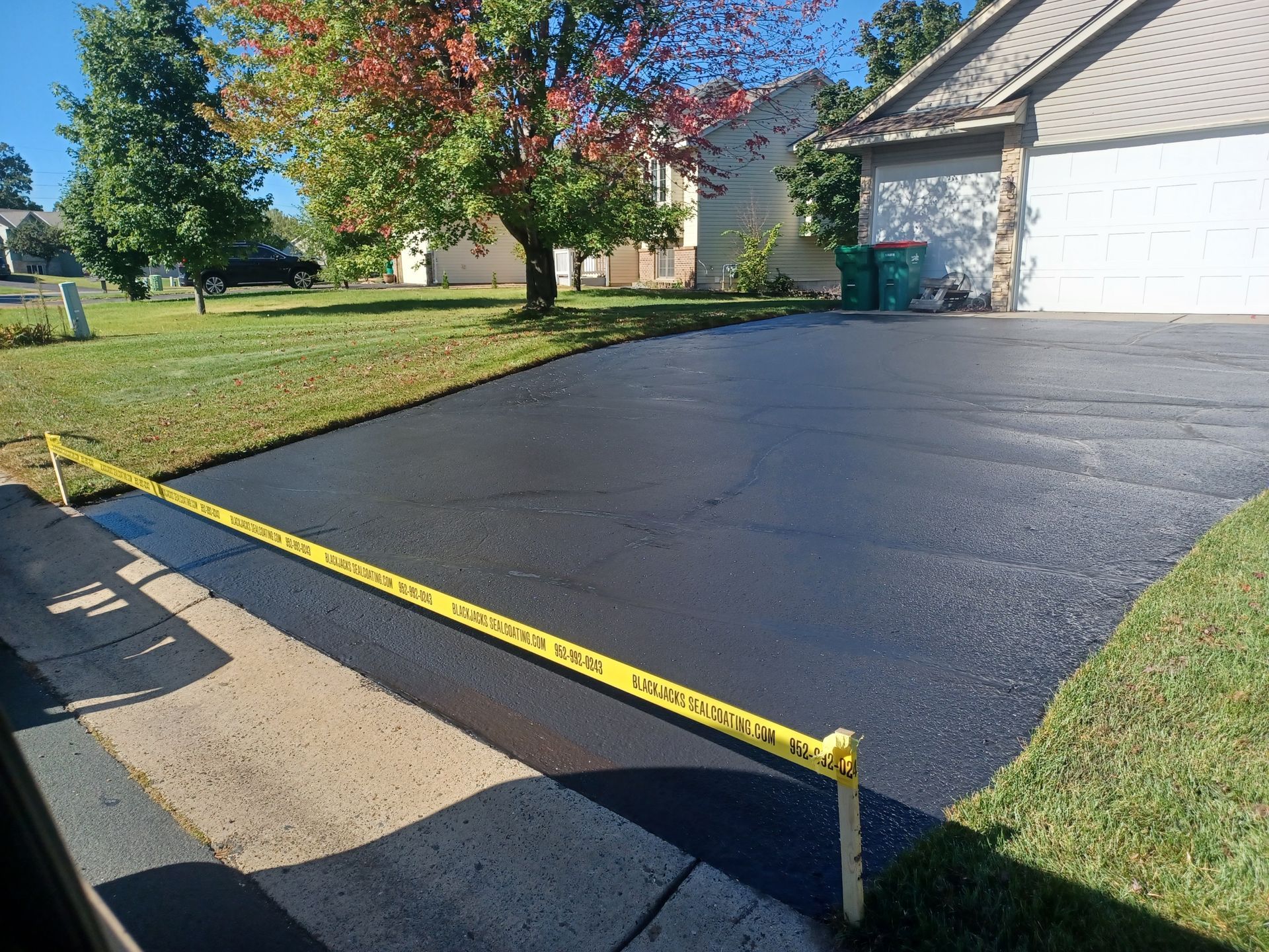 A driveway is being paved in front of a house.