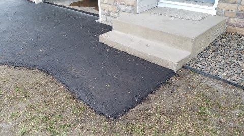 A sidewalk is being built in front of a house.