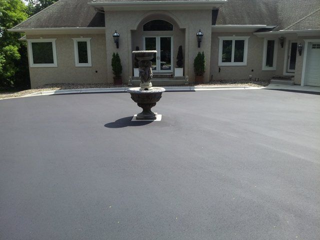 A large house with a fountain in front of it