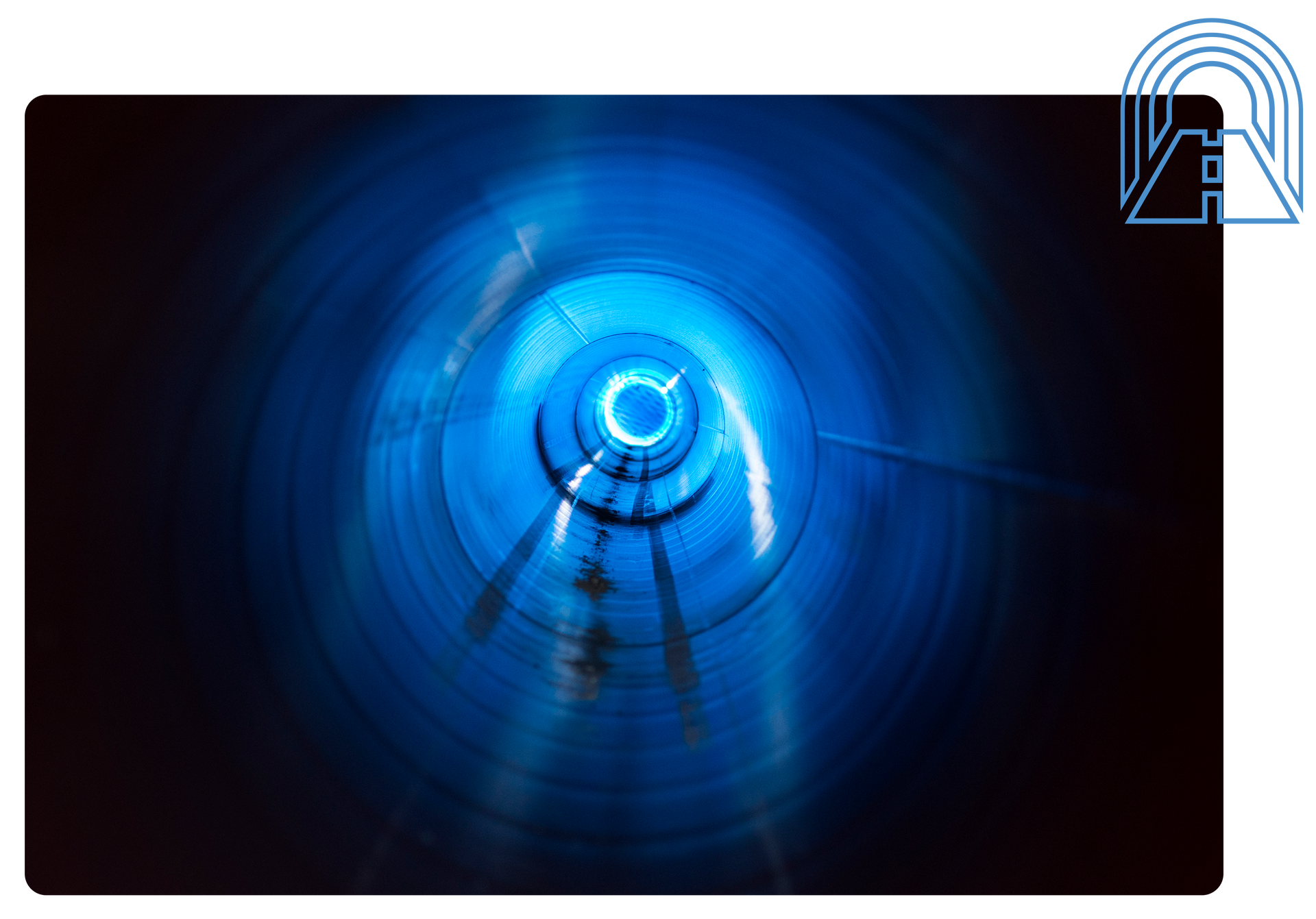 Blue tunnel, circular interior with bright light at the end.