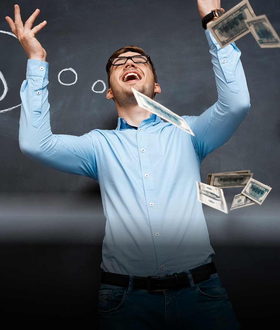 Man throwing money in the air, smiling, in front of a chalkboard.