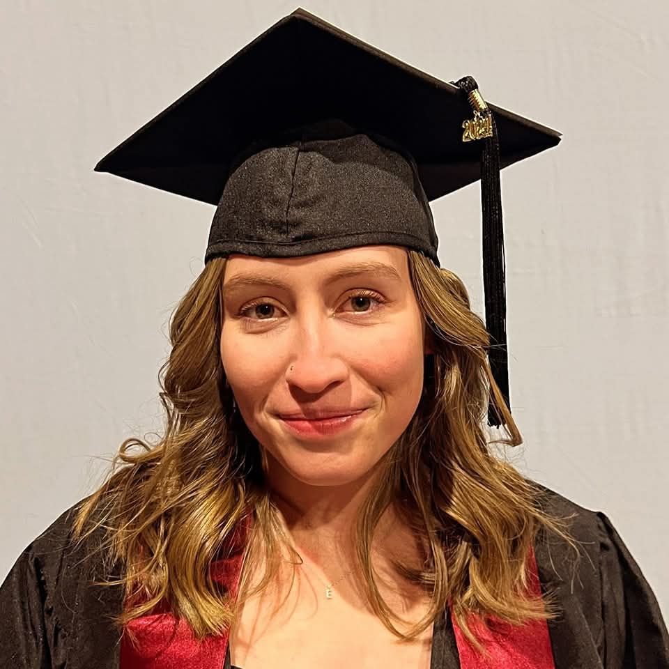A man with a beard and glasses is wearing a plaid shirt.
