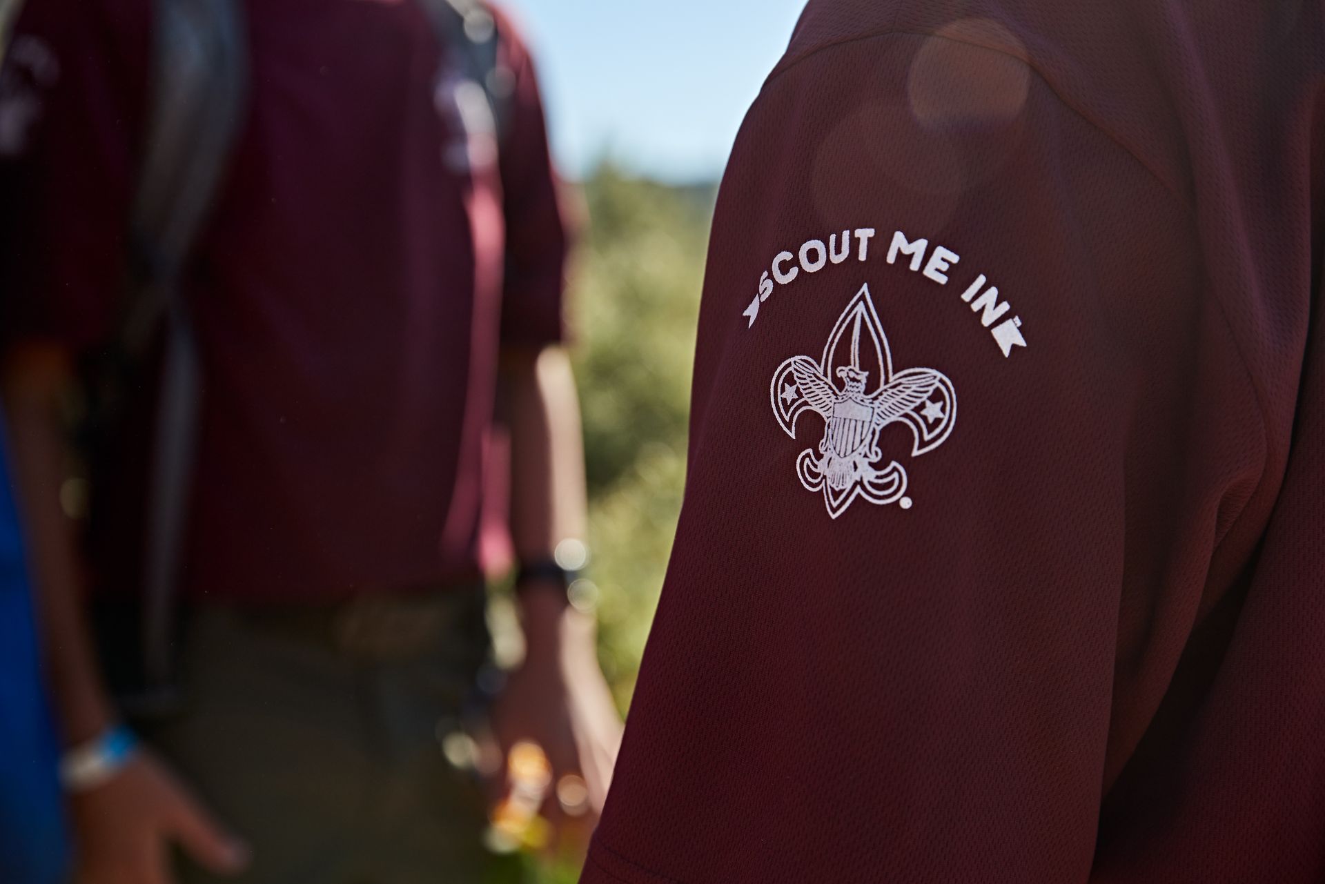 A close up of a person wearing a scout me ink shirt