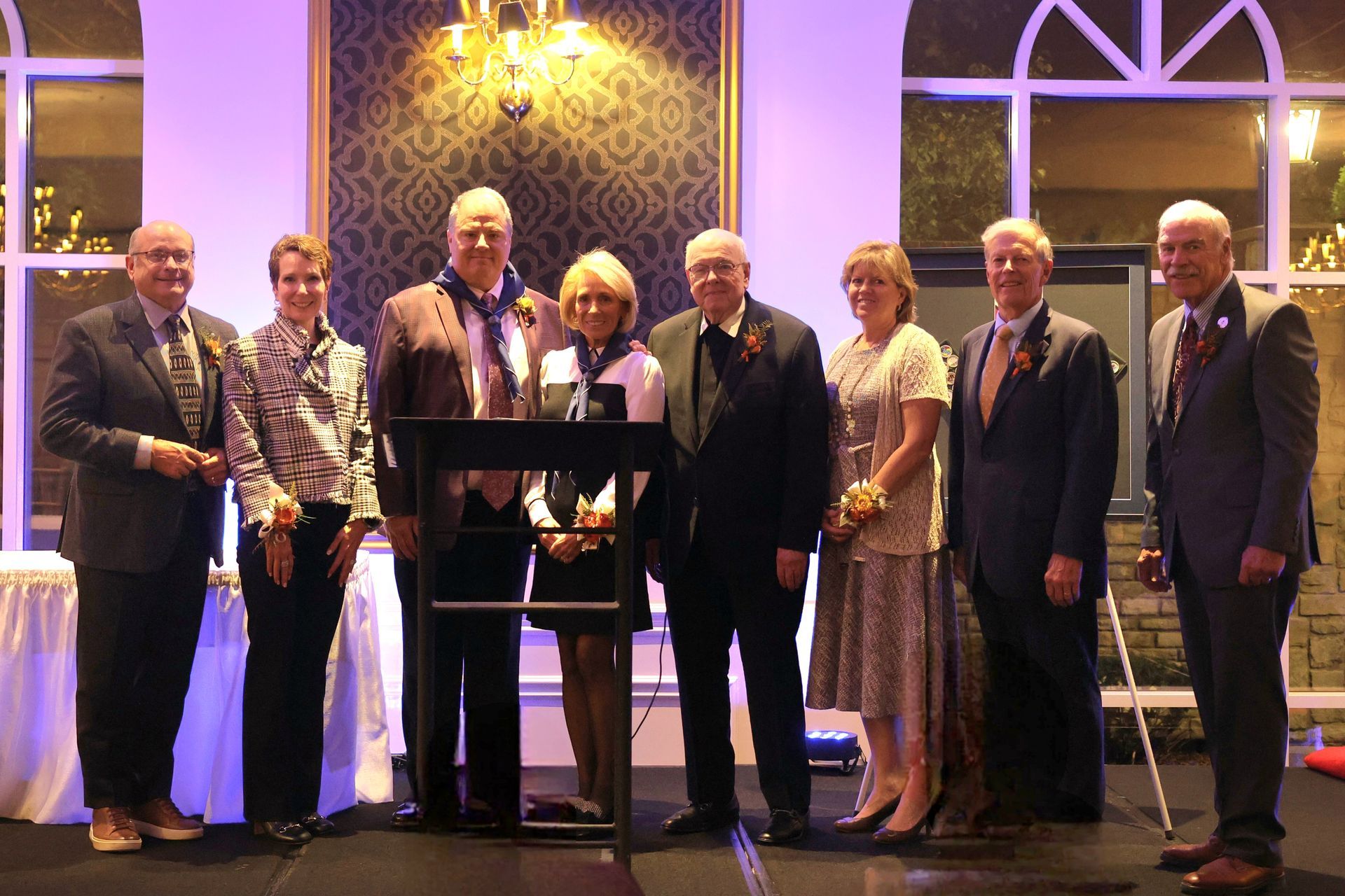 A group of people in suits and ties are posing for a picture.