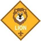 Cub Scout Lion rank emblem: cartoon lion face, brown mane, yellow diamond, fleur-de-lis.