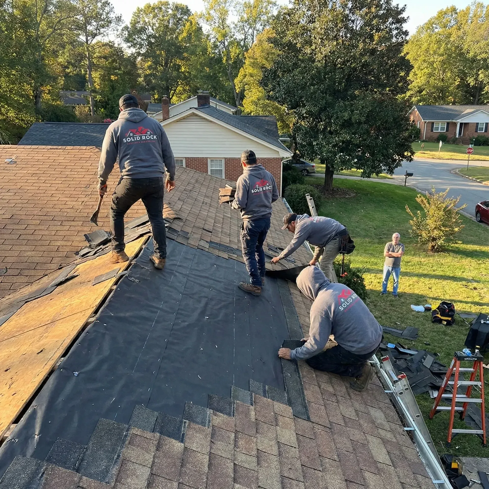 Trusted roofing companies Greensboro NC team installing new roof for local homeowner