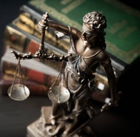 Lady Justice with law books in background
