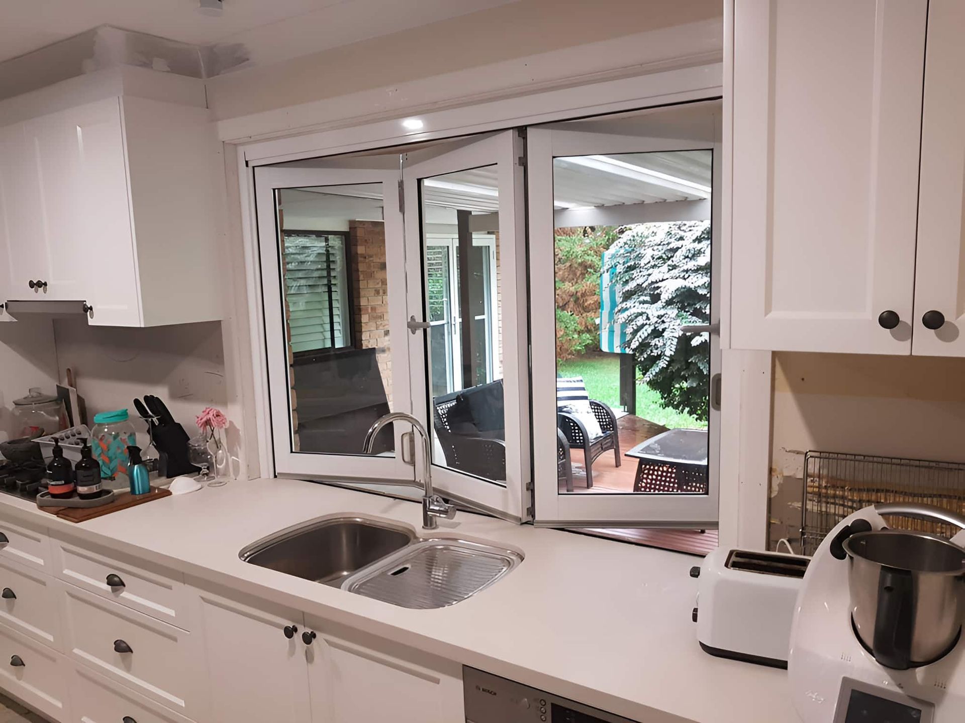 A Kitchen With A Sink And A Large Window — All Hours Glass In Culburra Beach, NSW