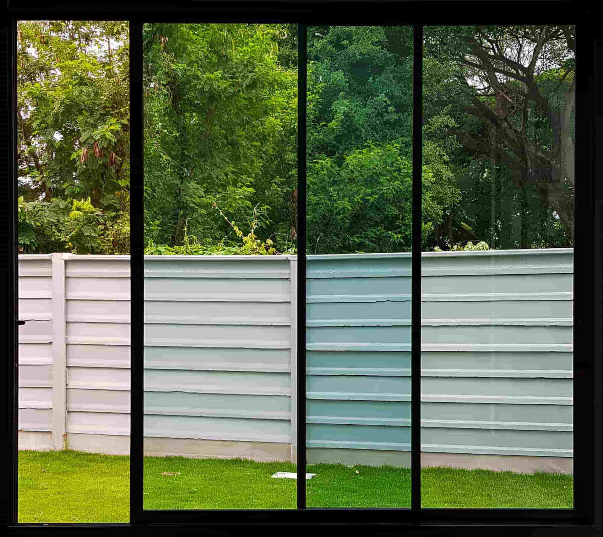 A Fence Is Visible Through A Sliding Glass Door — All Hours Glass In Culburra, NSW