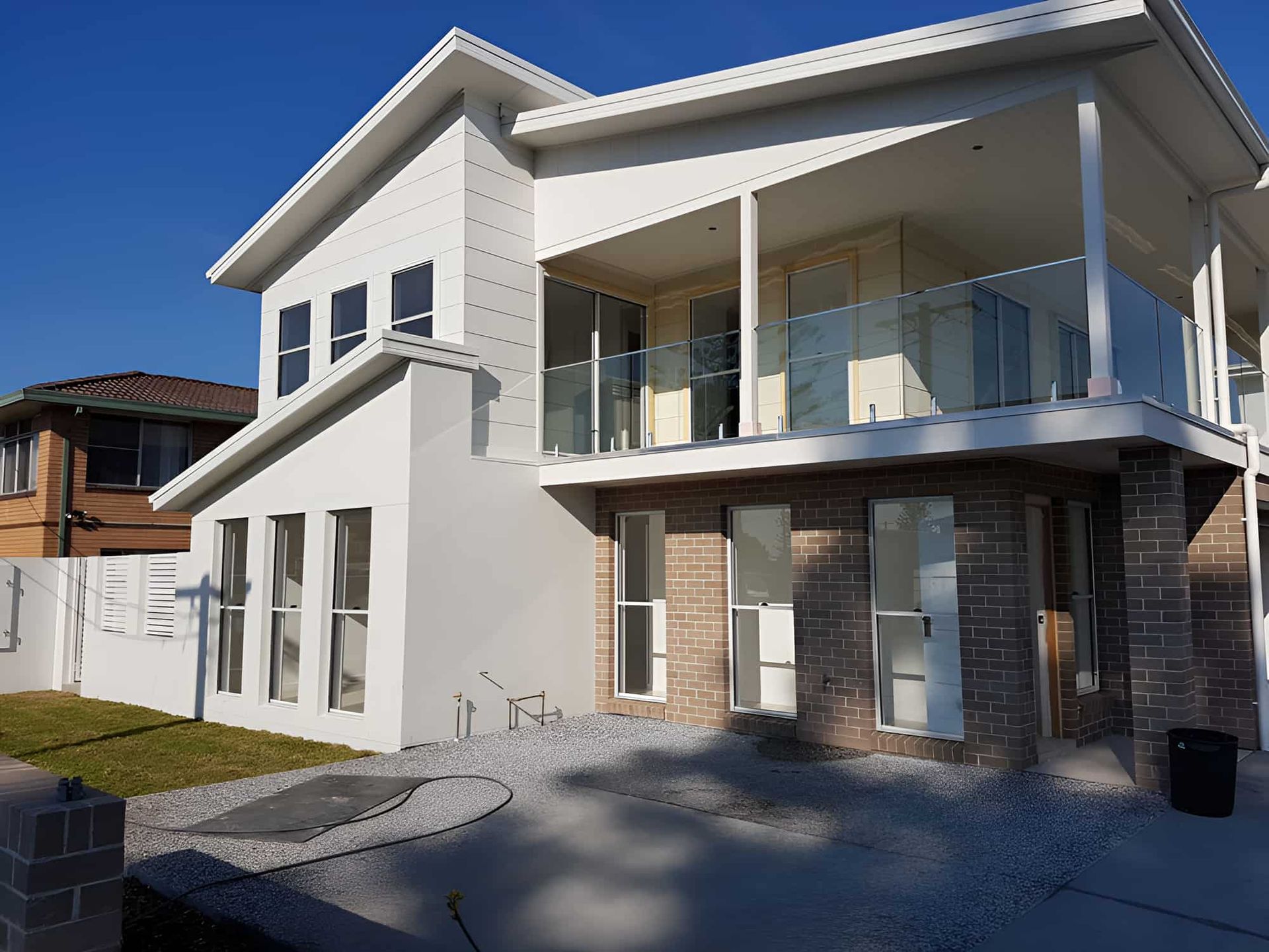A White House With A Balcony And A Blue Sky In The Background — All Hours Glass In Culburra Beach, NSW