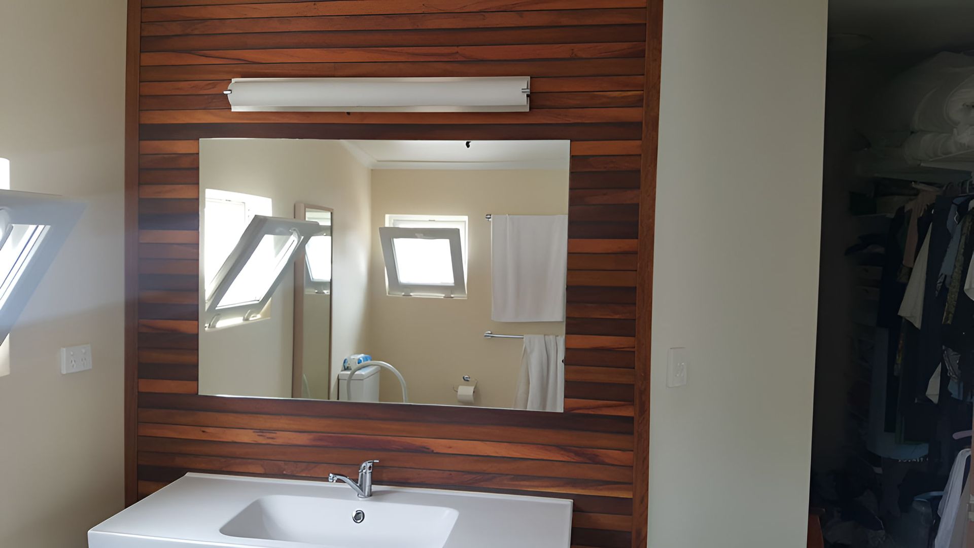 A Bathroom With A Sink And A Large Mirror — All Hours Glass In Culburra Beach, NSW