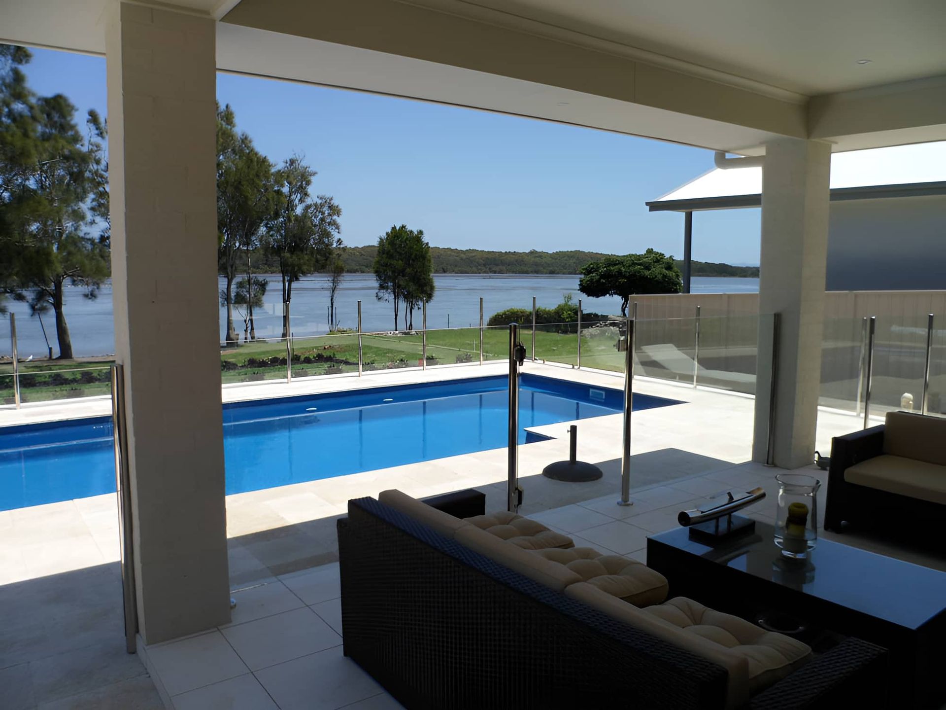 A View Of A Large Swimming Pool From A Patio — All Hours Glass In Culburra Beach, NSW