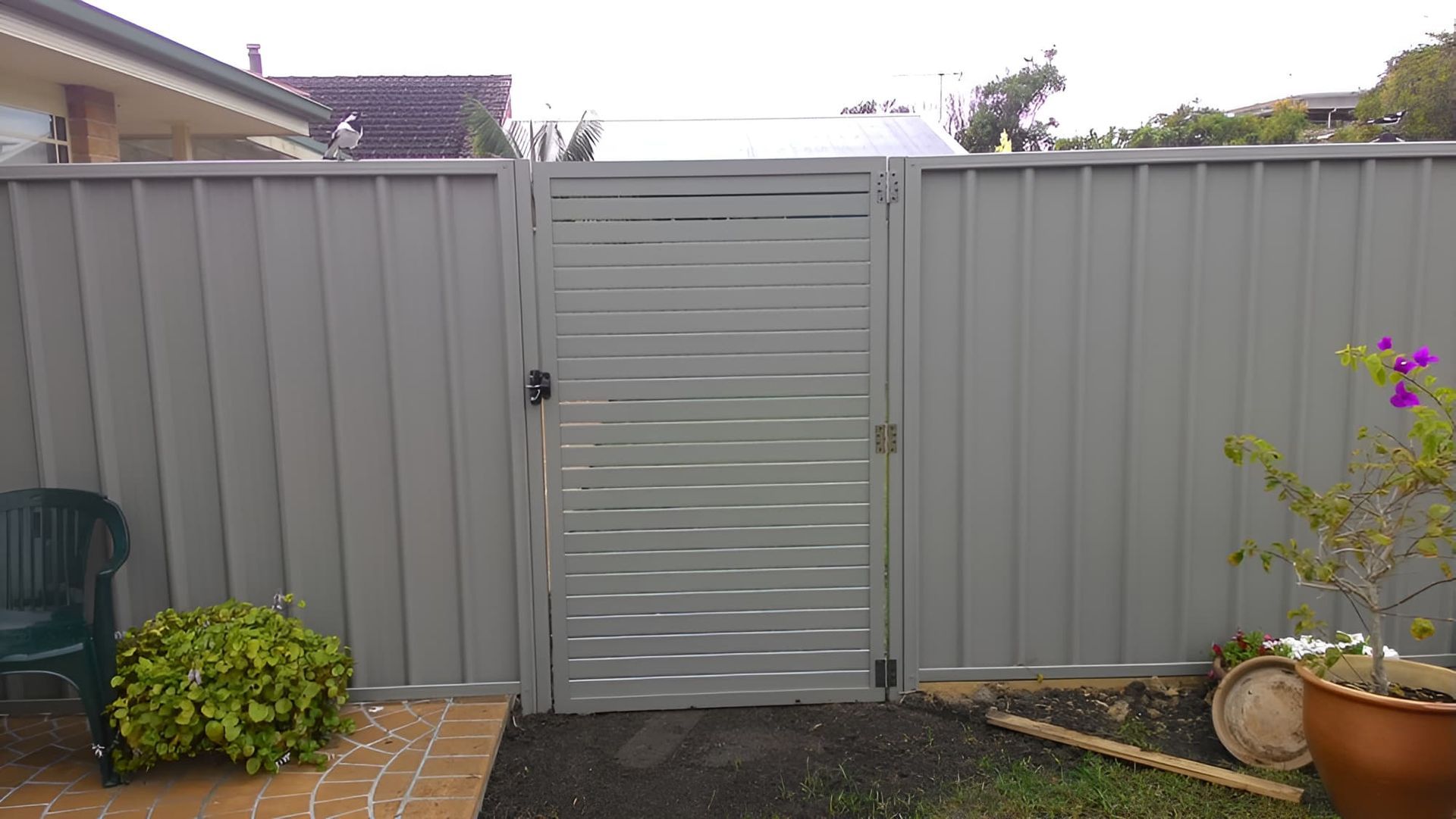 A Fence With A Gate And A Potted Plant In Front Of It — All Hours Glass In Culburra Beach, NSW