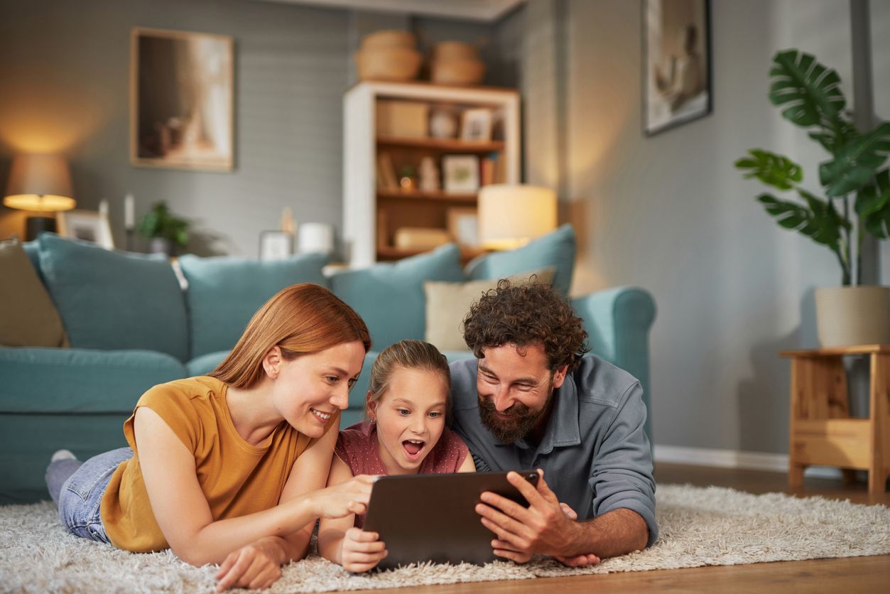 Woman and child looking at a tablet together indoors.