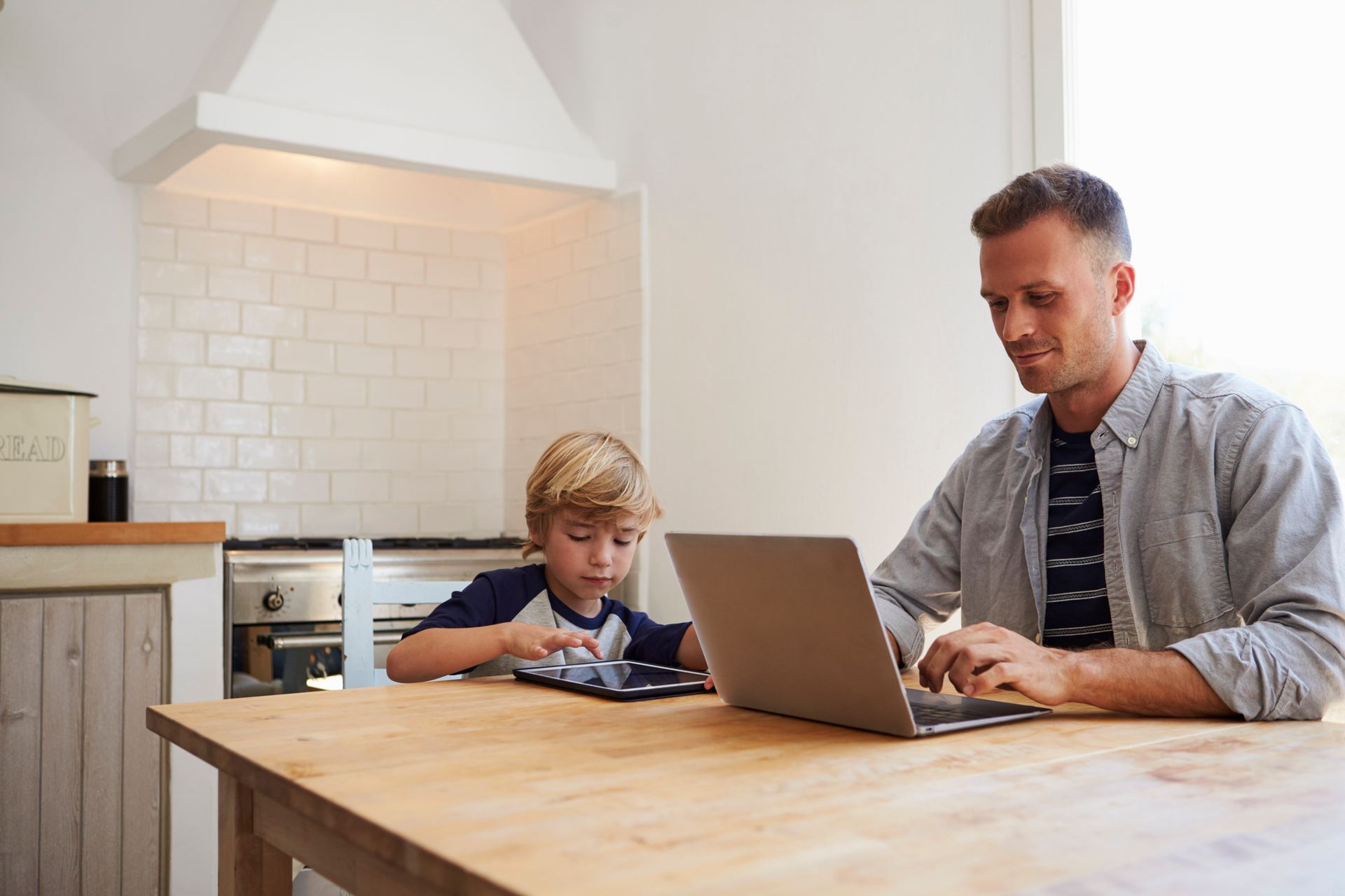 Family using a tablet and smartphone; app controls internet and devices.