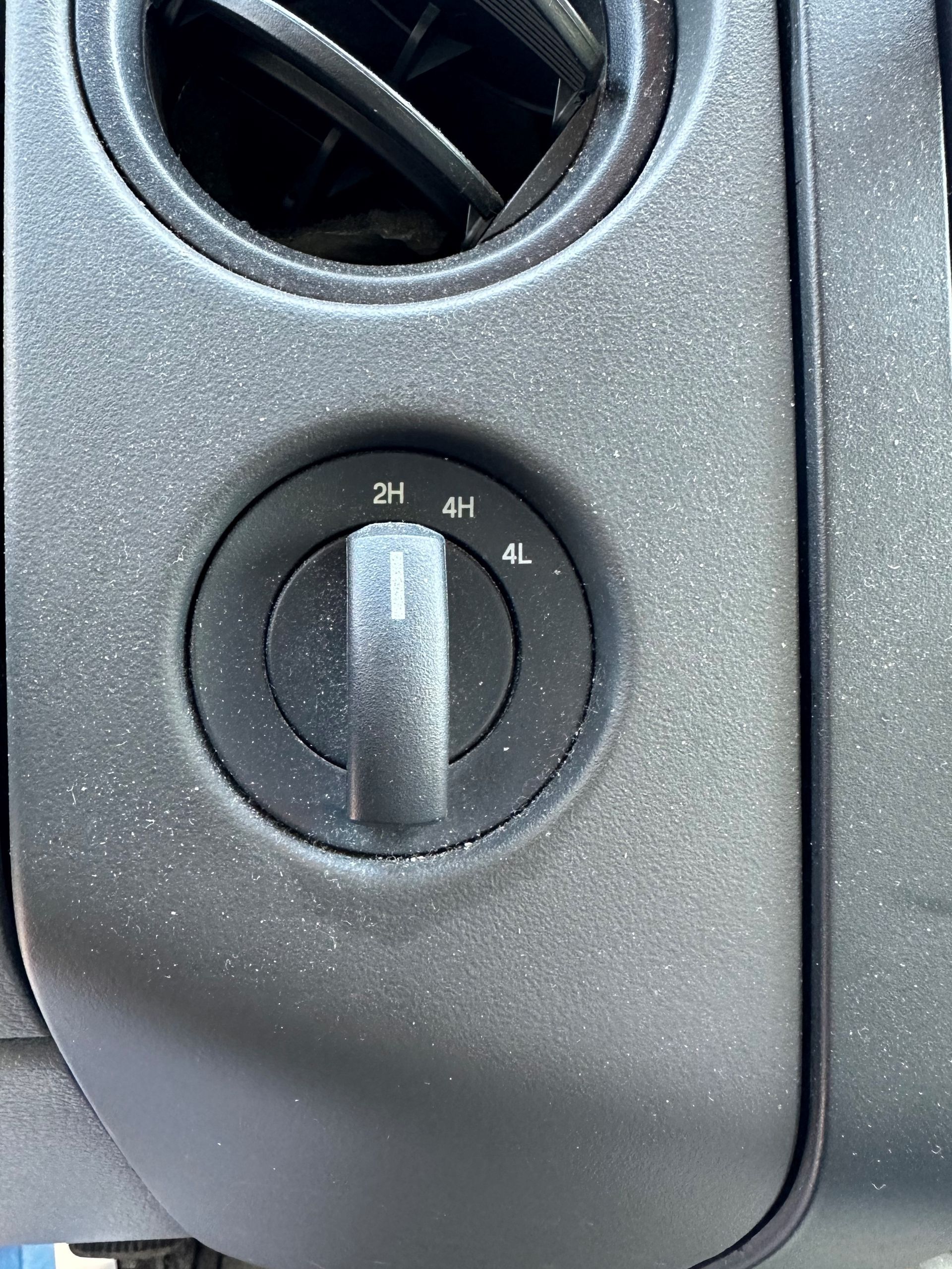 A close up of a switch on the side of a car. | Lou's Car Care Center Inc.