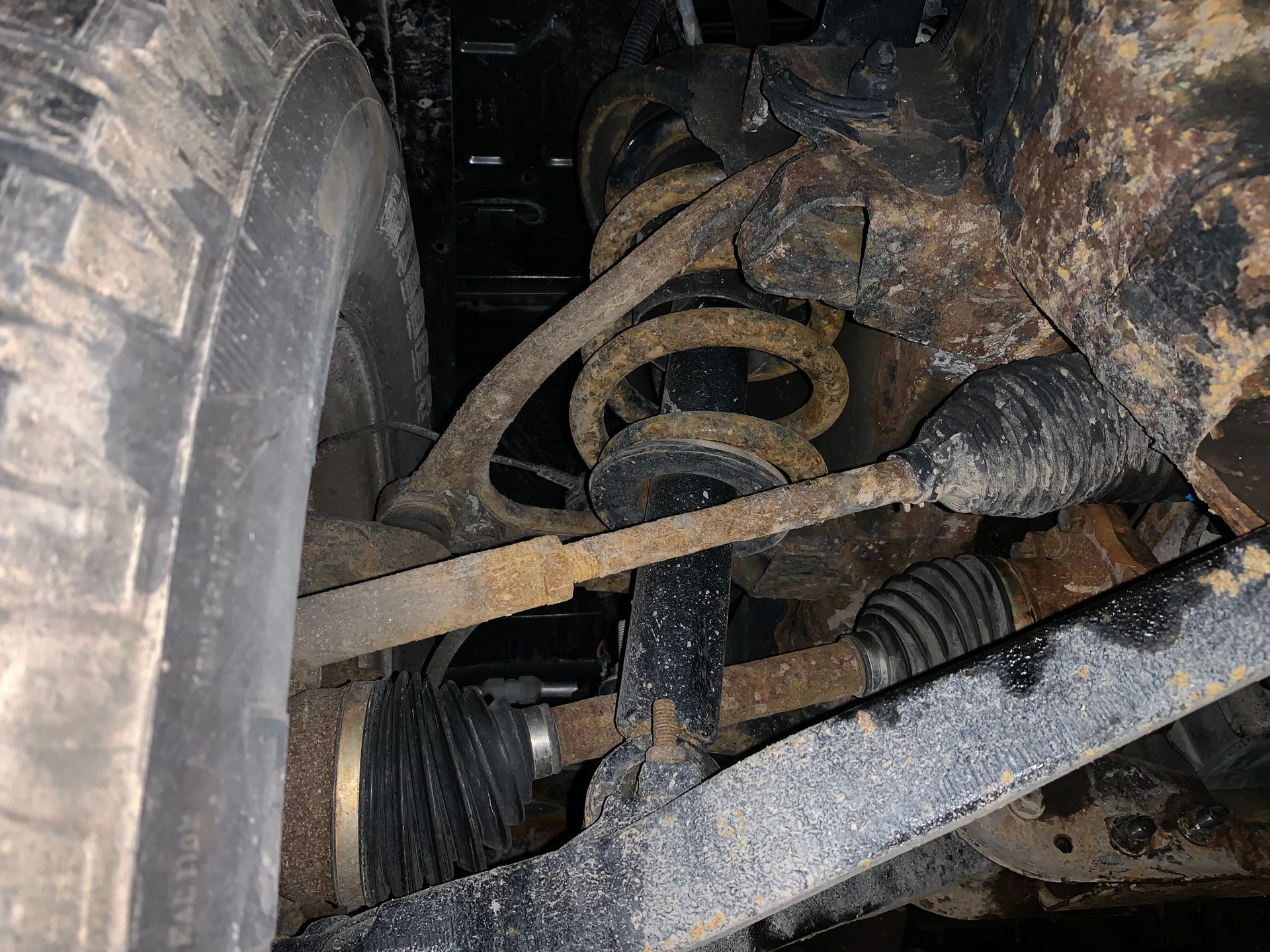 A close up of a rusty shock absorber on a car. | Lou's Car Care Center, Inc.