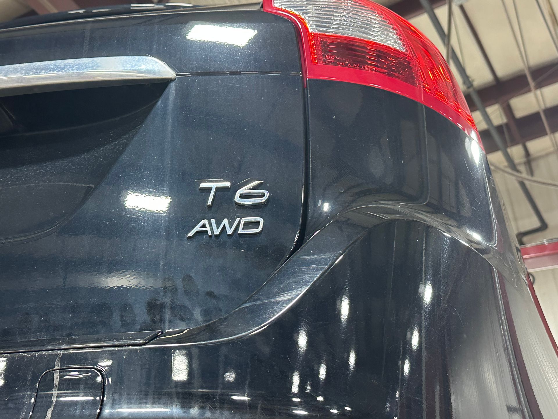 A black t6 awd car is parked in a garage | Lou's Car Care Center Inc.