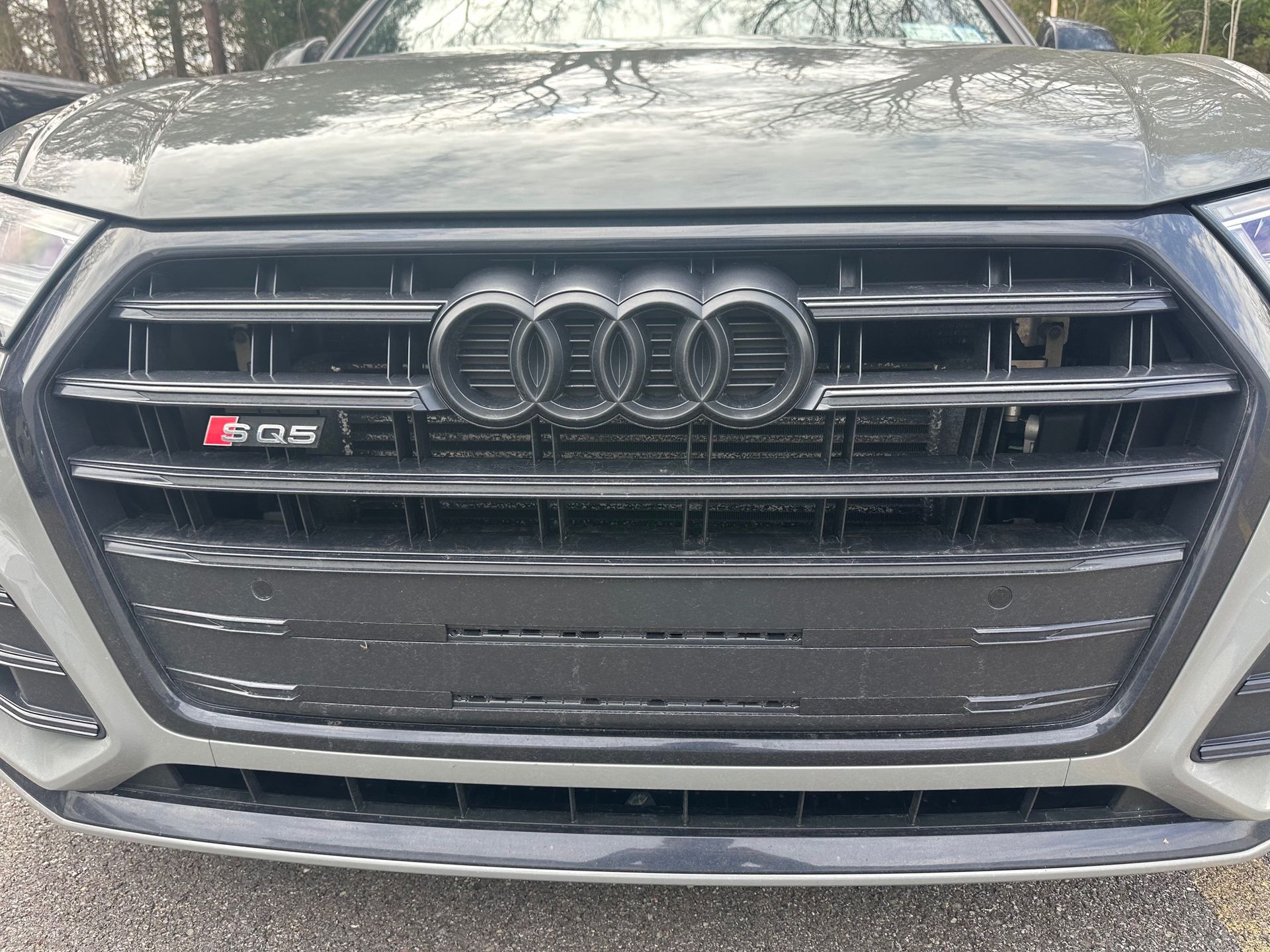 Audi ADAS sensors in front bumper grill on grey Audi.