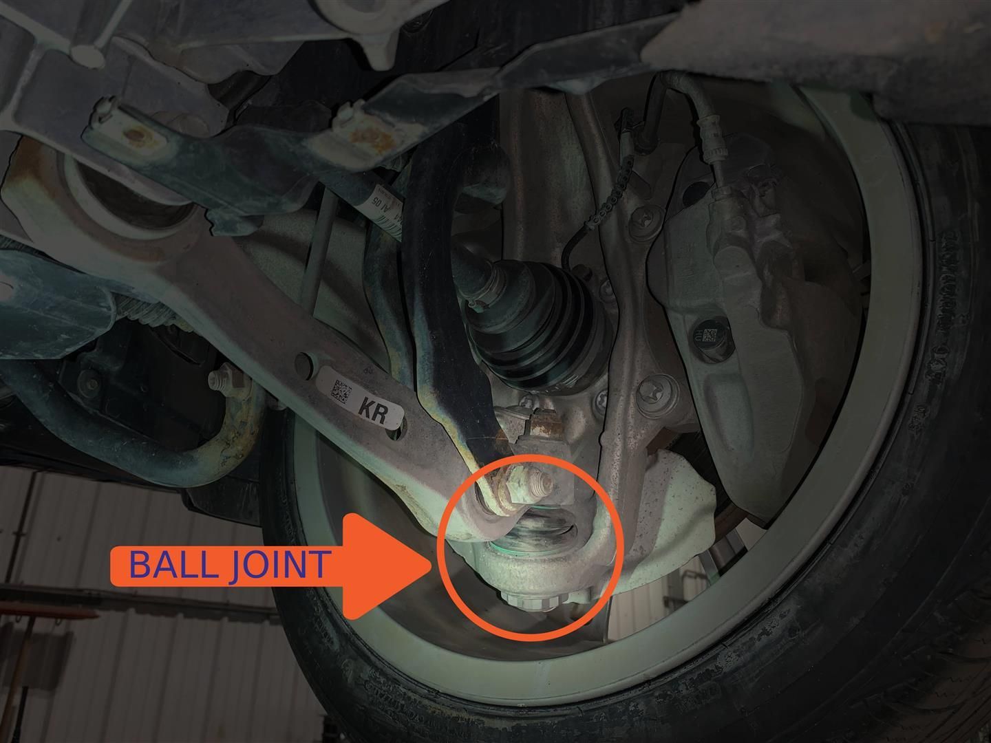 A close up of a ball joint on a car | Lou's Car Care Center, Inc.